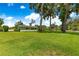 Expansive green yard with scattered mature shade trees surrounding the home at 1922 Se 13Th St, Ocala, FL 34471