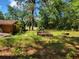 Backyard features a firepit and gardening bed and is surrounded by mature trees at 20045 Sw 88Th Place Rd, Dunnellon, FL 34431