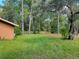 Side view of a home with lush trees in the backyard, offering a private, wooded setting at 20045 Sw 88Th Place Rd, Dunnellon, FL 34431