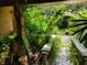 The front entrance is adorned with lush foliage and decor leading to the walkway and front door at 20045 Sw 88Th Place Rd, Dunnellon, FL 34431