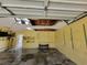 Garage interior shows water damage on walls and ceiling, with visible shelving at 20045 Sw 88Th Place Rd, Dunnellon, FL 34431