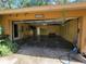 View of open garage with shelving, open back door, and visible water damage at 20045 Sw 88Th Place Rd, Dunnellon, FL 34431