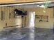 Spacious garage area with shelving, an open doorway, and visible water damage at 20045 Sw 88Th Place Rd, Dunnellon, FL 34431