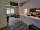 Open kitchen with breakfast bar, stainless steel appliances, and modern tile flooring at 20045 Sw 88Th Place Rd, Dunnellon, FL 34431