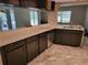 Kitchen featuring ample counter space, undermount stainless sink and view of the screened in porch at 20045 Sw 88Th Place Rd, Dunnellon, FL 34431