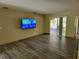 Spacious living room featuring sliding glass doors and wood-look tile flooring at 20045 Sw 88Th Place Rd, Dunnellon, FL 34431