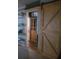 Rustic bathroom with barn door, wood shelving, and an accent light fixture at 2312 Ne 37Th St, Ocala, FL 34479