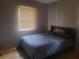 Comfortable bedroom featuring hardwood floors and a window at 2312 Ne 37Th St, Ocala, FL 34479