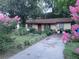 Charming single-story home featuring a well-maintained yard and colorful landscaping at 2312 Ne 37Th St, Ocala, FL 34479