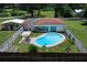 Aerial view of property with pool, fenced yard, patio, and lush surrounding greenery at 2340 Ne 14Th Ave, Ocala, FL 34470