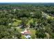 Drone shot of property nestled among trees, highlighting a pool and verdant surroundings at 2340 Ne 14Th Ave, Ocala, FL 34470