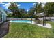 This backyard boasts a covered patio with outdoor seating and a refreshing in ground pool at 2340 Ne 14Th Ave, Ocala, FL 34470