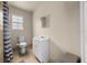 Modest bathroom features a toilet, sink with vanity, a mirror, and a shower with neutral walls at 2340 Ne 14Th Ave, Ocala, FL 34470