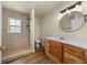 Bathroom with a wooden vanity, shower, and neutral color palette at 2340 Ne 14Th Ave, Ocala, FL 34470