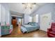 Bright bedroom with hardwood floors, natural light, a cozy seating area, and ample storage at 2340 Ne 14Th Ave, Ocala, FL 34470