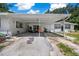 Covered carport with cozy seating area perfect for relaxing and enjoying the outdoors at 2340 Ne 14Th Ave, Ocala, FL 34470