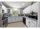 Bright kitchen with white cabinets, stainless steel appliances, and a view of the greenery outside the window at 2340 Ne 14Th Ave, Ocala, FL 34470