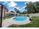 Outdoor pool, white privacy fence, home exterior, and manicured lawn provides a relaxing outdoor space at 2340 Ne 14Th Ave, Ocala, FL 34470