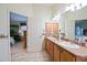 Bathroom featuring a double sink vanity, neutral color palette, and access to the bedroom at 3146 Williams Rd, The Villages, FL 32162