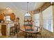 Cozy dining area with round wood table, bar, and lots of natural light from the window at 3146 Williams Rd, The Villages, FL 32162