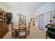 Dining area featuring a round wooden table and chandelier, situated near an open doorway and providing ample seating at 3146 Williams Rd, The Villages, FL 32162