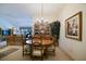Dining area with a round wooden table and chandelier, seamlessly connects to the living area, perfect for gatherings at 3146 Williams Rd, The Villages, FL 32162