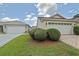 Two-car garage exterior with manicured landscaping, enhancing curb appeal and providing ample parking at 3146 Williams Rd, The Villages, FL 32162
