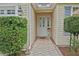 Charming front entrance with a brick pathway, a well maintained lawn and a welcoming entryway at 3146 Williams Rd, The Villages, FL 32162