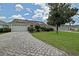 Charming single-story home with a well-manicured lawn and a brick driveway at 3146 Williams Rd, The Villages, FL 32162