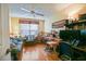 Cozy home office with hardwood floors, built-in shelving, and a ceiling fan for a comfortable workspace at 3146 Williams Rd, The Villages, FL 32162