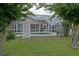 Backyard pool view showcasing a screened enclosure and mature trees at 3146 Williams Rd, The Villages, FL 32162