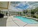 Beautiful screened-in pool surrounded by serene landscaping and clear blue skies at 3146 Williams Rd, The Villages, FL 32162