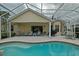 View of the outdoor pool with a screened-in patio and comfortable seating area at 3146 Williams Rd, The Villages, FL 32162