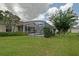 Spacious backyard featuring a screened-in pool and well-maintained landscaping at 3146 Williams Rd, The Villages, FL 32162