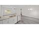 Open floor plan with modern kitchen featuring a breakfast bar at 3268 Sw 149Th Pl, Ocala, FL 34481
