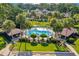 Aerial view of community pool featuring mature landscaping and poolside canopies at 3707 Ne 17Th St, Ocala, FL 34470