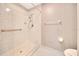 Roll-in shower with white tile surround and grab bars for accessibility at 3707 Ne 17Th St, Ocala, FL 34470
