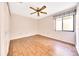 This bedroom features wood floors, a ceiling fan, and a window that lets in natural light at 3707 Ne 17Th St, Ocala, FL 34470