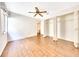 This bedroom features wood floors, a ceiling fan, and a closet with bi-fold doors at 3707 Ne 17Th St, Ocala, FL 34470