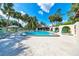 Inviting community pool with lounge chairs surrounded by lush tropical landscaping at 3707 Ne 17Th St, Ocala, FL 34470