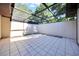 Tiled enclosed lanai with a partial skylight, ready for outdoor relaxation and entertainment at 3707 Ne 17Th St, Ocala, FL 34470