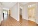 Hallway with hardwood floors leading to a bathroom and living area with sliding glass doors at 3707 Ne 17Th St, Ocala, FL 34470