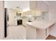 Compact kitchen featuring white cabinets, corner sink, and a ceiling fan at 3707 Ne 17Th St, Ocala, FL 34470