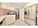 Bright kitchen features stainless steel refrigerator and opens to the living room at 3707 Ne 17Th St, Ocala, FL 34470