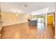 Bright living room with hardwood floors, fireplace, and sliding glass doors to enclosed patio at 3707 Ne 17Th St, Ocala, FL 34470