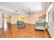 Spacious living room with wood floors and large windows provides ample natural light at 3707 Ne 17Th St, Ocala, FL 34470
