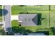 Overhead shot highlighting roof and manicured lawn of home, showcasing neat landscaping and neighborhood at 3948 Se 4Th Ter, Ocala, FL 34480