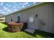 Exterior shot of home showcasing a backyard door and well-maintained lawn at 3948 Se 4Th Ter, Ocala, FL 34480