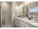 Well-lit bathroom with double sinks, a large mirror, and modern fixtures at 3948 Se 4Th Ter, Ocala, FL 34480