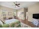 Bright bedroom with hardwood floors, two windows, and an ensuite bathroom at 3948 Se 4Th Ter, Ocala, FL 34480